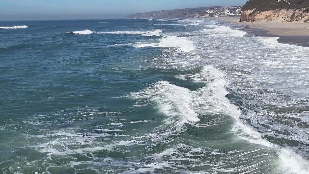 Aerial footage over the beach and cliffs at Bom Sucesso.